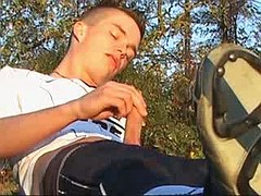 Cute twink flashes and cums in outdoor on grass